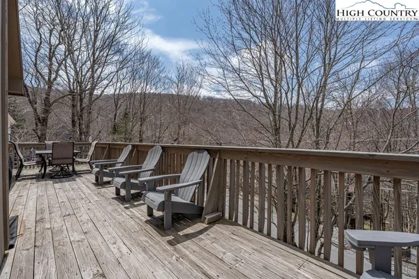 a roof deck with wooden floor and fence