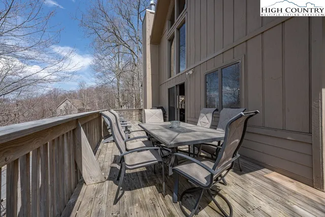 a view of backyard with table and chairs and wooden floor