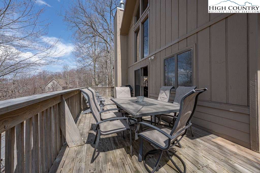 136 Tamarack Road Beech Mountain, NC 28604 - Photo 19 of 20 a view of backyard with table and chairs and wooden floor