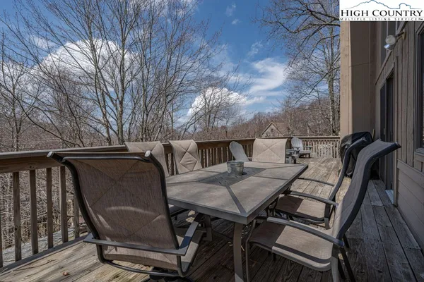 a view of deck with table and chairs and wooden floor