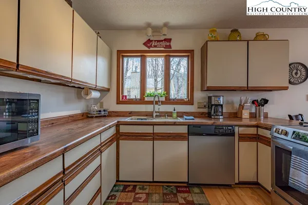 a kitchen with stainless steel appliances a sink stove and cabinets