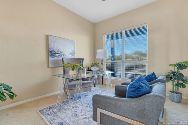 a living room with furniture and a potted plant