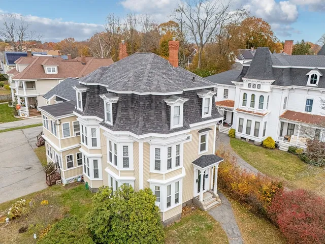 an aerial view of a house with a yard