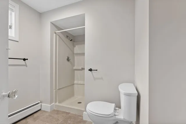 a bathroom with a granite countertop toilet a sink and shower