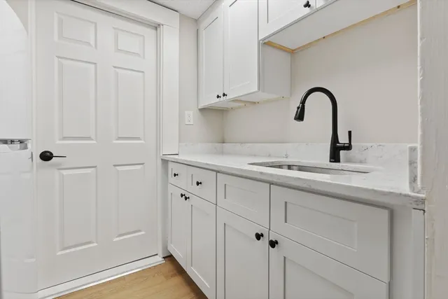 a close view of a sink and cabinets in the kitchen