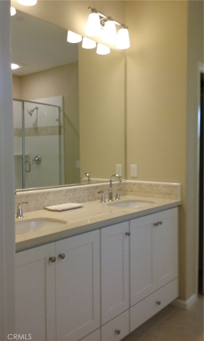 182 Working Ranch Irvine, CA 92602 - Photo 18 of 21 a bathroom with a sink and a mirror