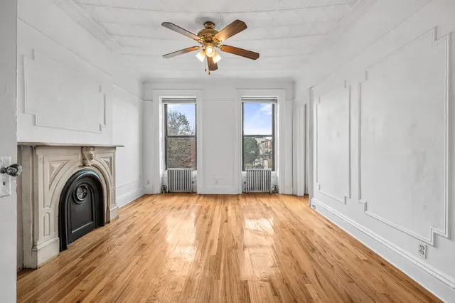 a view of a room with wooden floor and glass door