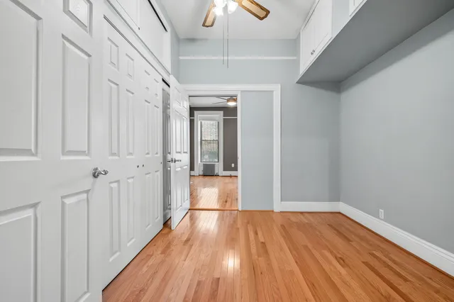 a view of empty room with fireplace and wooden floor