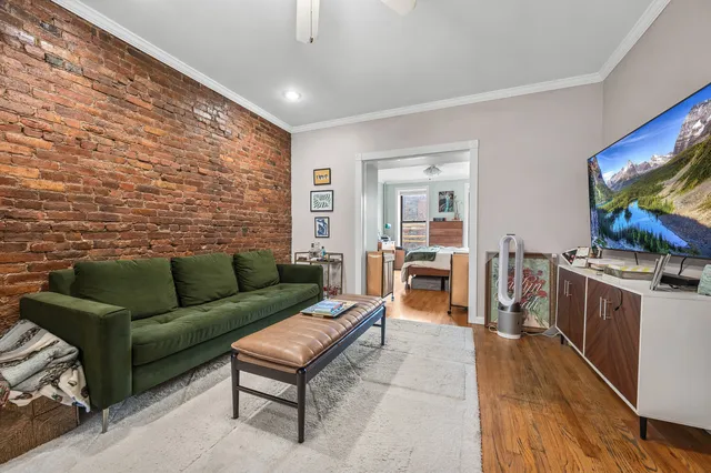a kitchen with stainless steel appliances granite countertop a table chairs and a refrigerator