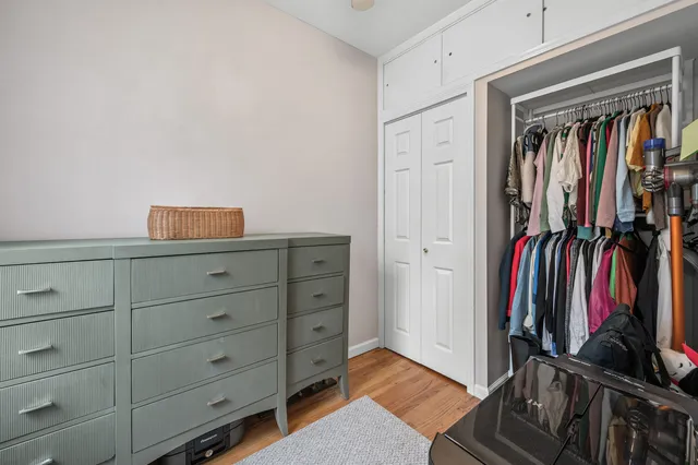 a view of empty room with fireplace chandelier fan and windows