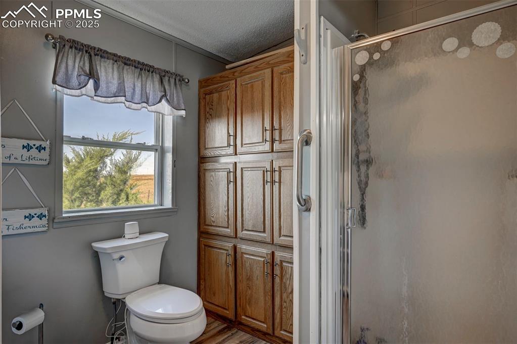 35355 Funk Road Calhan, CO 80808 - Photo 24 of 31 a bathroom with a toilet a sink and shower