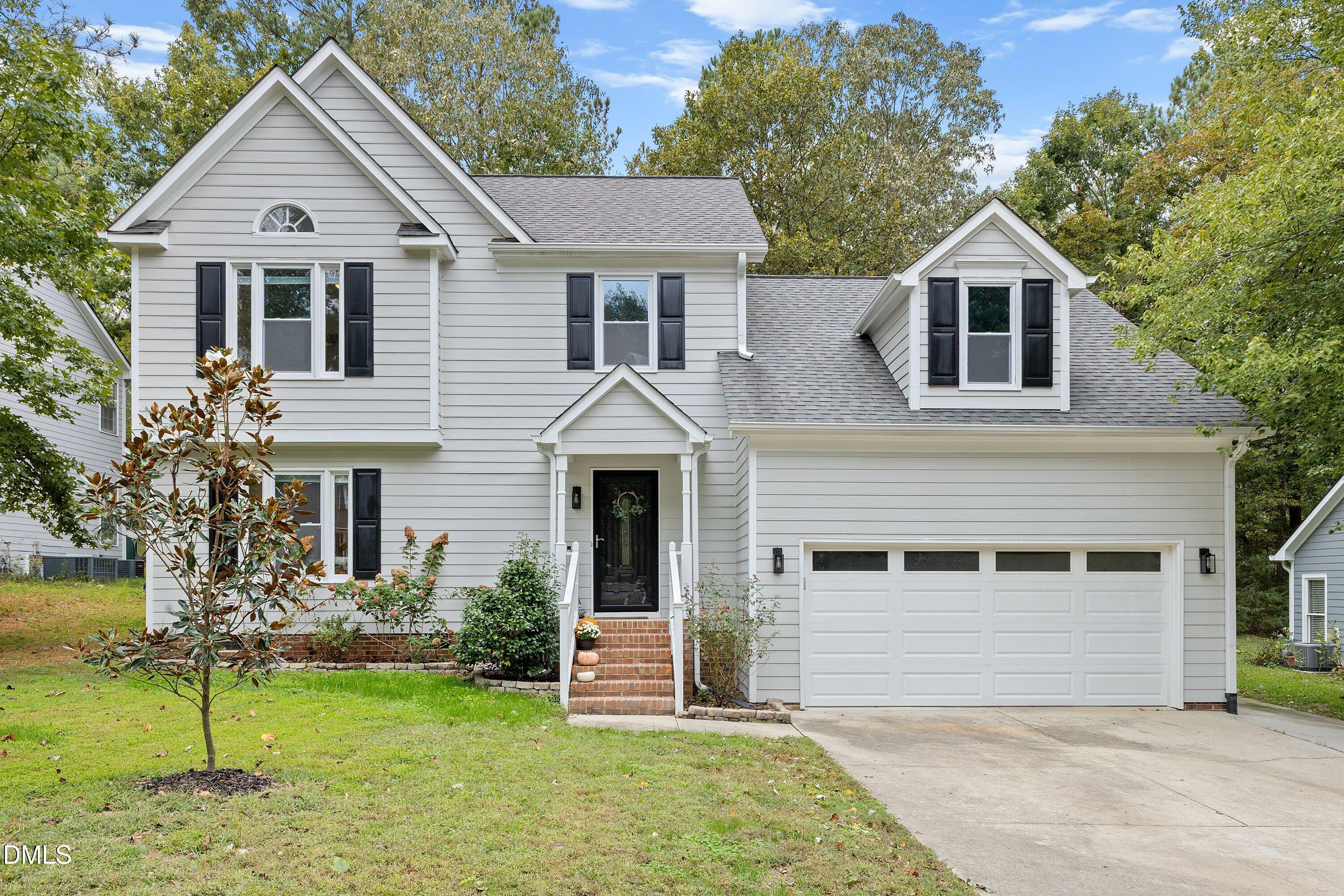 5310 Reams Run Road Durham, NC 27713 - Photo 1 of 38 a front view of a house with a yard and garage