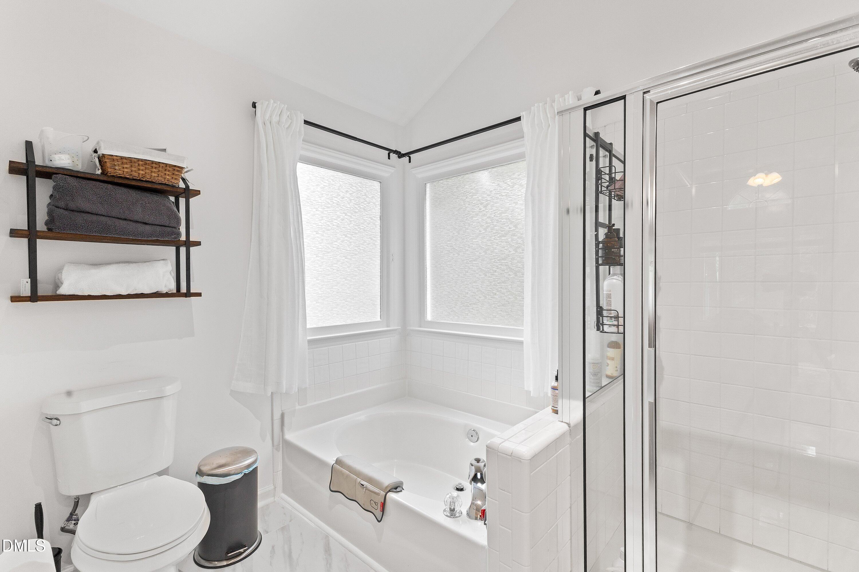 5310 Reams Run Road Durham, NC 27713 - Photo 26 of 38 a bathroom with a shower a bathtub and a toilet