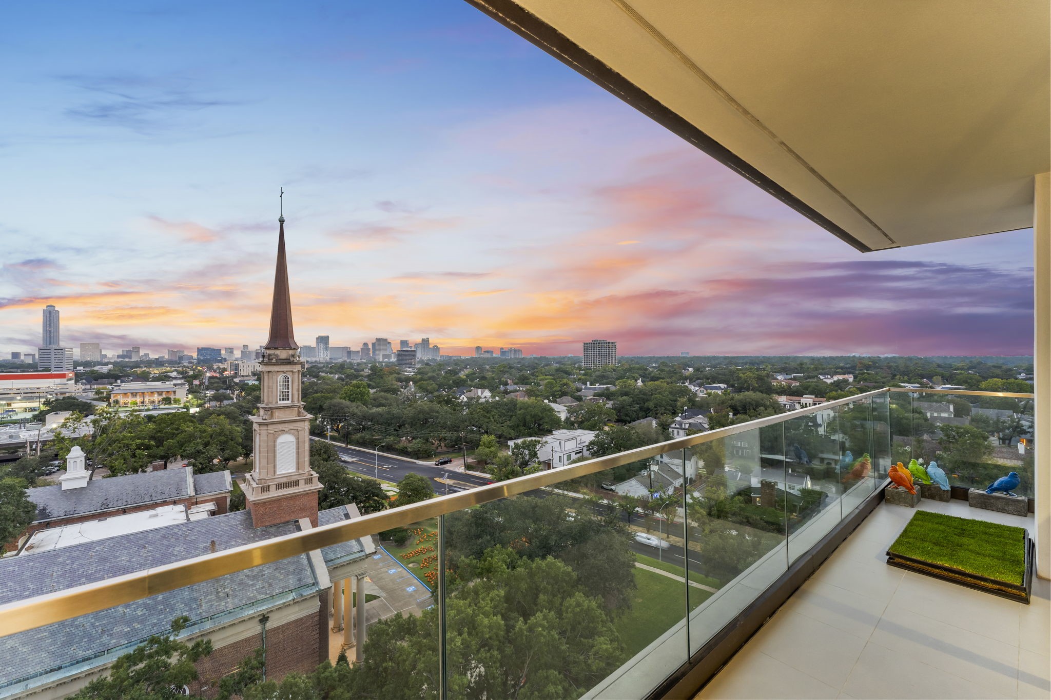 3433 Westheimer Road, Unit 1005 Houston, TX 77027 - Photo 15 of 47 Protected treetops, River Oaks landmarks, and saturated sunsets that stretch the evening. The glass rail keeps views pristine.