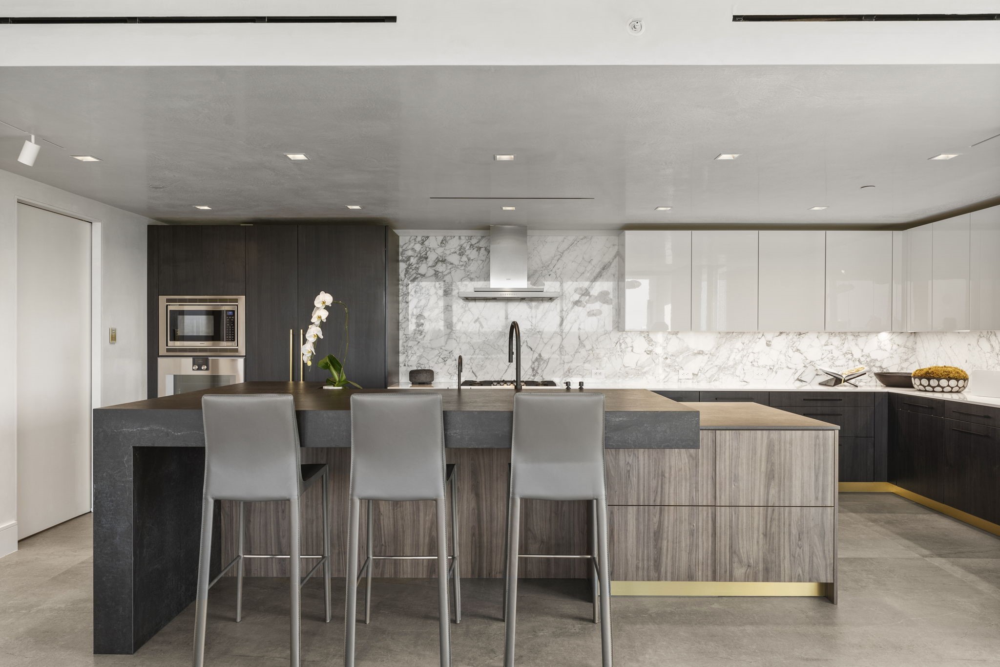 3433 Westheimer Road, Unit 1005 Houston, TX 77027 - Photo 17 of 47 A magazine-worthy workspace: Poggenpohl cabinetry and Dekton waterfall island anchor a full Gaggenau suite centered by The Galley workstation sink for serious prep.