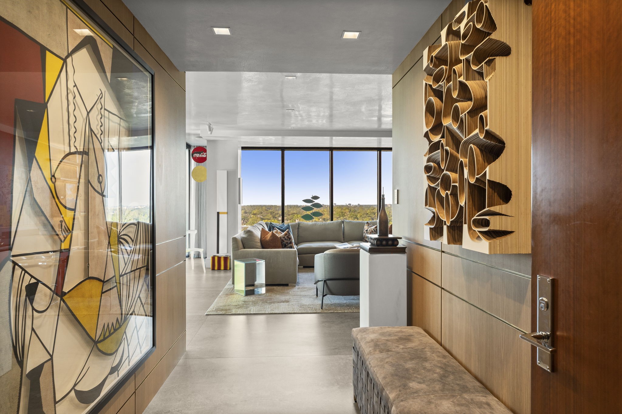 3433 Westheimer Road, Unit 1005 Houston, TX 77027 - Photo 2 of 47 Fumed white oak panels detailed with brass inlay announce the home’s craftsmanship.