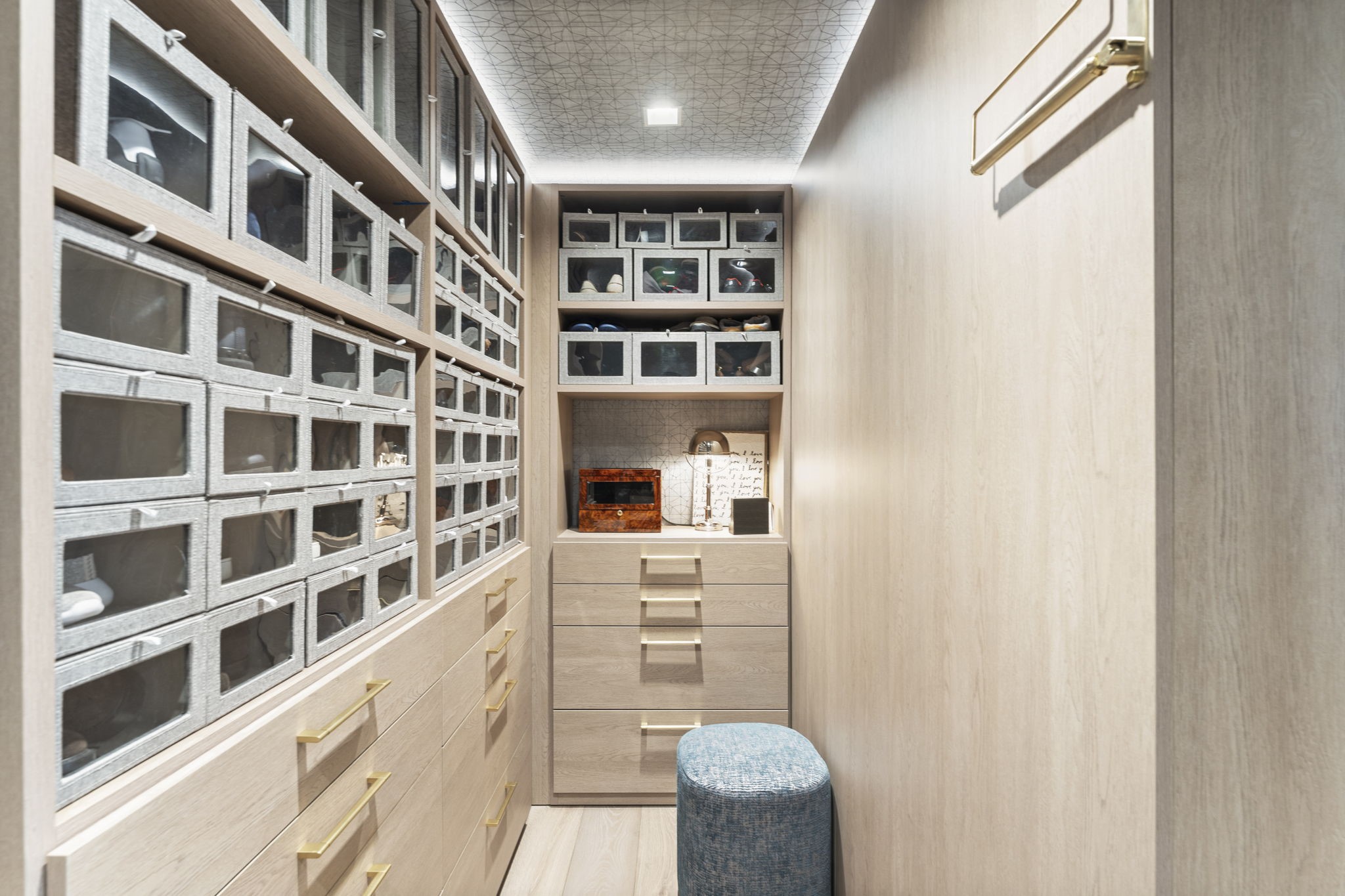 3433 Westheimer Road, Unit 1005 Houston, TX 77027 - Photo 27 of 47 Tailored millwork with Holly Hunt wallpaper and cove lighting overhead; a gentleman’s atelier with everything within reach.