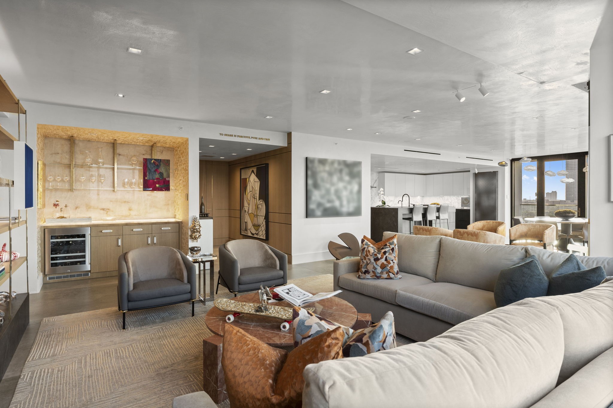 3433 Westheimer Road, Unit 1005 Houston, TX 77027 - Photo 4 of 47 Entertainer's hub: back-lit quartzite bar with custom brass-bracketed shelving, fumed white oak cabinetry.