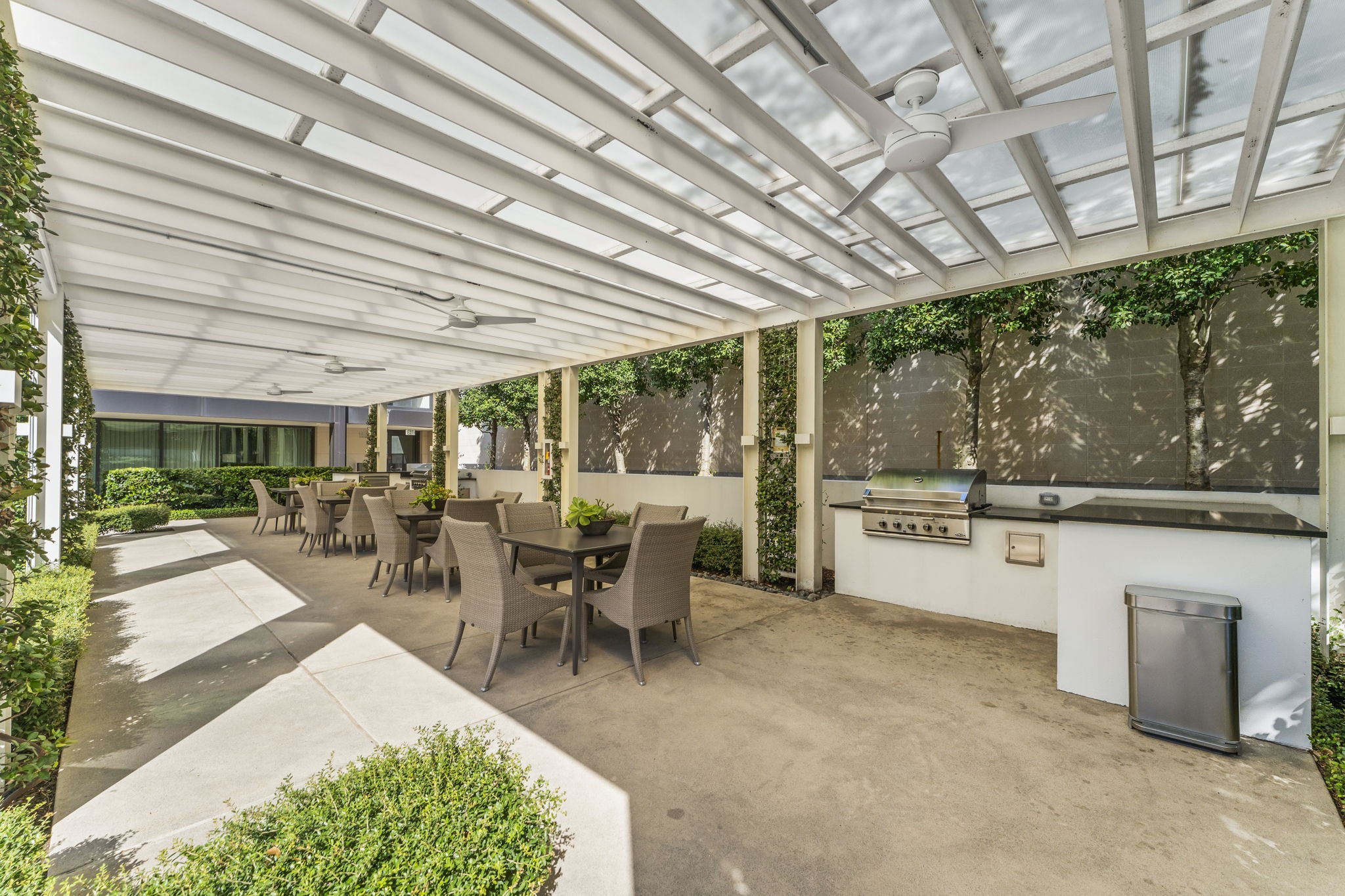 3433 Westheimer Road, Unit 1005 Houston, TX 77027 - Photo 45 of 47 Entertain al fresco under the pergola: summer kitchen with grill, prep space, and generous dining beside the pool.
