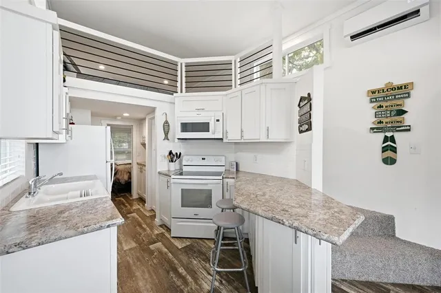 a large white kitchen with a large window