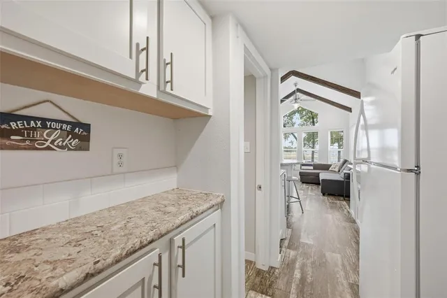 a bathroom with a granite countertop toilet sink and mirror