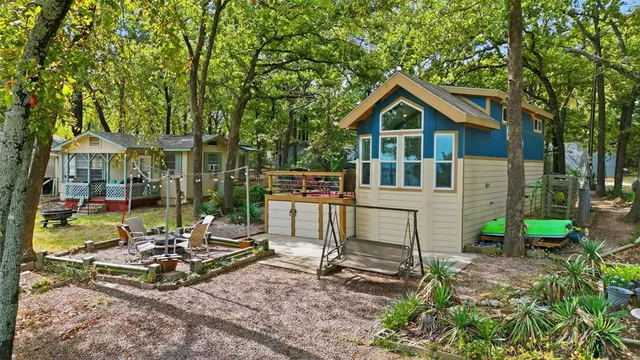 a view of a house with backyard and sitting area