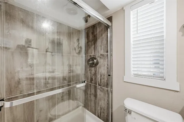 a kitchen with stainless steel appliances kitchen island granite countertop a refrigerator and a sink