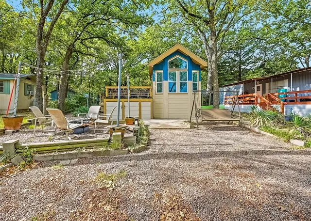 a view of a patio with table and chairs under an umbrella