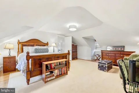 a bedroom with furniture and a gym machine