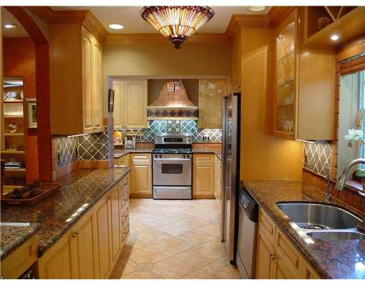 645 North Victoria Park Road Fort Lauderdale, FL 33304 - Photo 12 of 25 a kitchen with stainless steel appliances granite countertop a sink stove and refrigerator