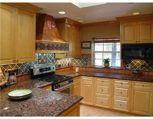 645 North Victoria Park Road Fort Lauderdale, FL 33304 - Photo 14 of 25 a kitchen with sink a stove and cabinets