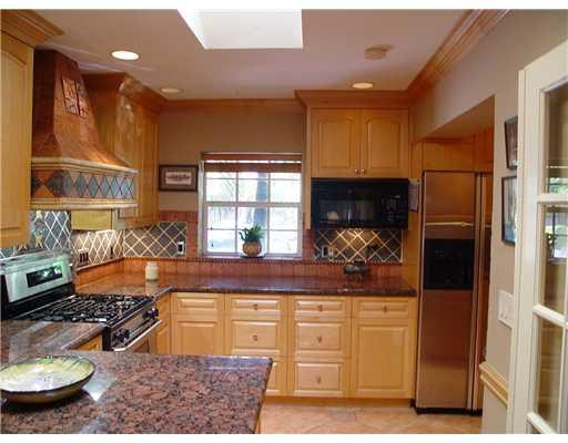 645 North Victoria Park Road Fort Lauderdale, FL 33304 - Photo 15 of 25 a kitchen with stainless steel appliances granite countertop a stove and a refrigerator