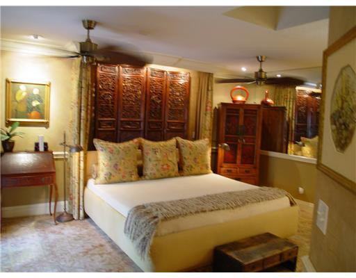 645 North Victoria Park Road Fort Lauderdale, FL 33304 - Photo 18 of 25 a bedroom with a large bed and a chandelier