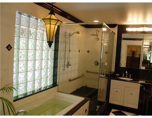 645 North Victoria Park Road Fort Lauderdale, FL 33304 - Photo 19 of 25 a bathroom with a granite countertop sink a mirror and shower