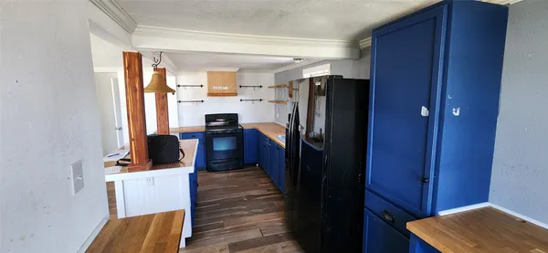 a view of a hallway with wooden floor and a livingroom