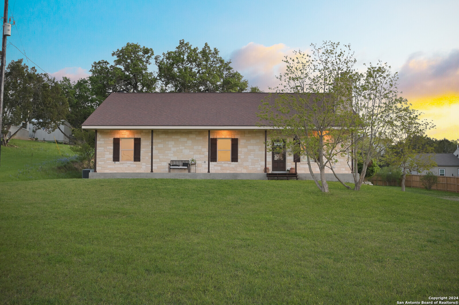 a front view of a house with a garden