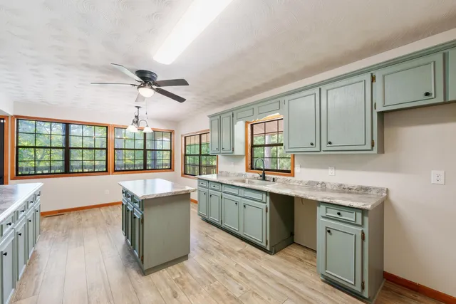 a kitchen with a sink stove and cabinets