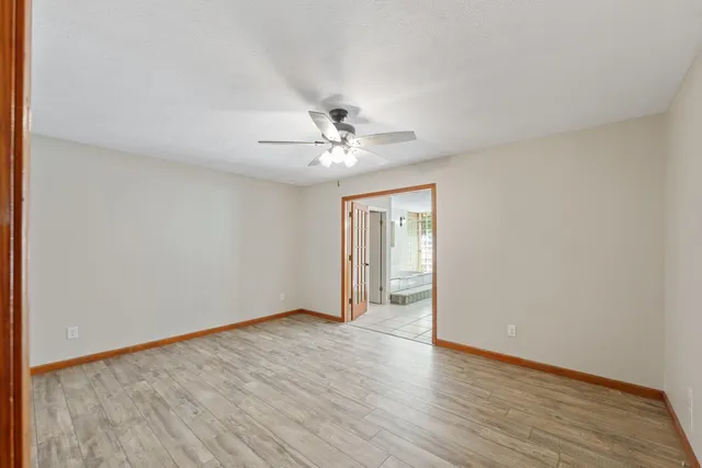 a view of an empty room with wooden floor