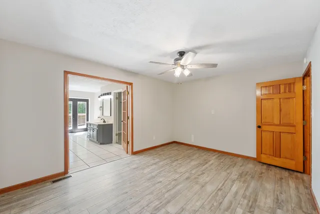 a view of a room with wooden floor and natural light