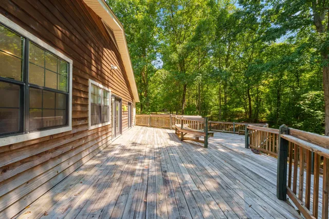 a view of roof deck with wooden floor and seating space