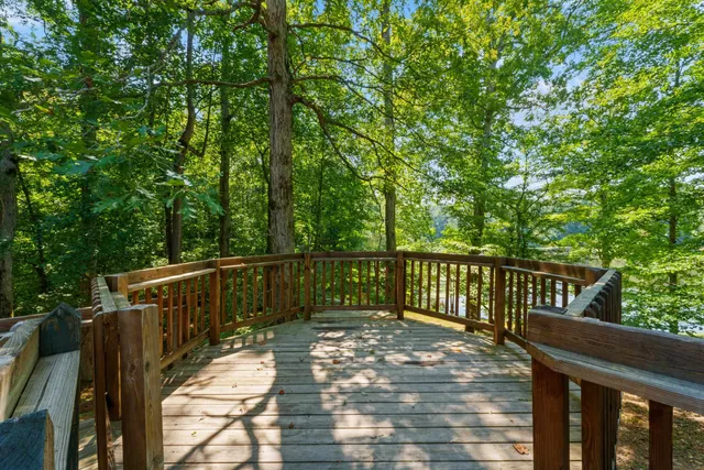 a view of balcony with wooden floor and fence