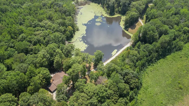 an aerial view of a house with yard and outdoor seating