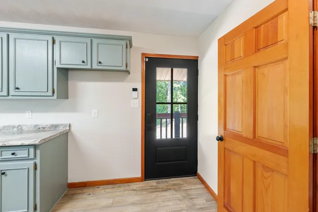 a view of front door with wooden floor