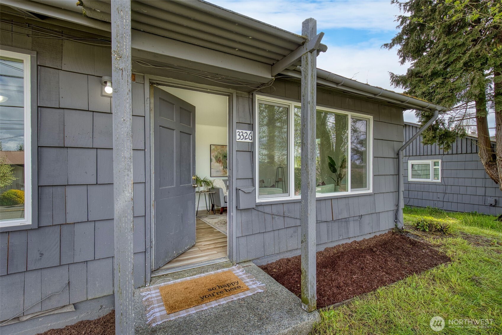 3326-3328 Halverson Avenue Bremerton, WA 98310 - Photo 3 of 36 a view of a porch with couches chairs and wooden fence