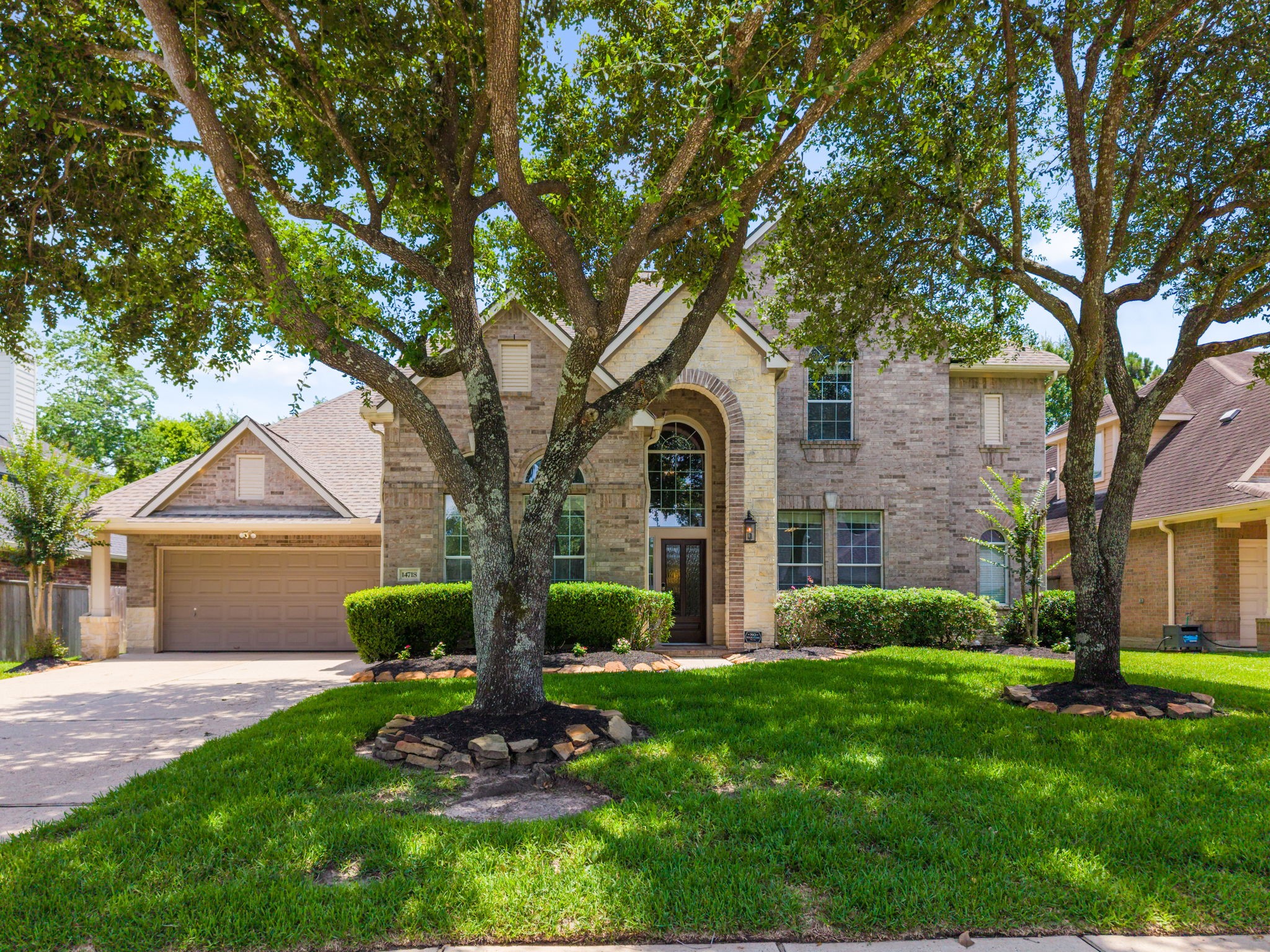 14718 Ramblebrook Humble, TX 77396 - Photo 2 of 38 A welcoming first impression framed by mature trees and classic architecture.