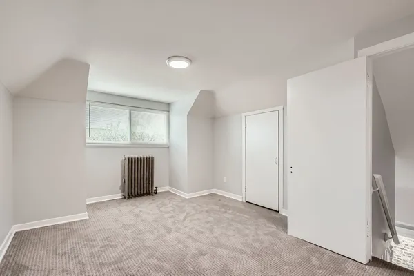 an empty room with windows and closet