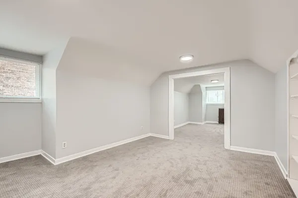 an empty room with windows and closet
