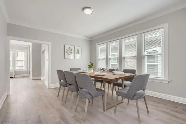 a view of a dining room with furniture and wooden floor