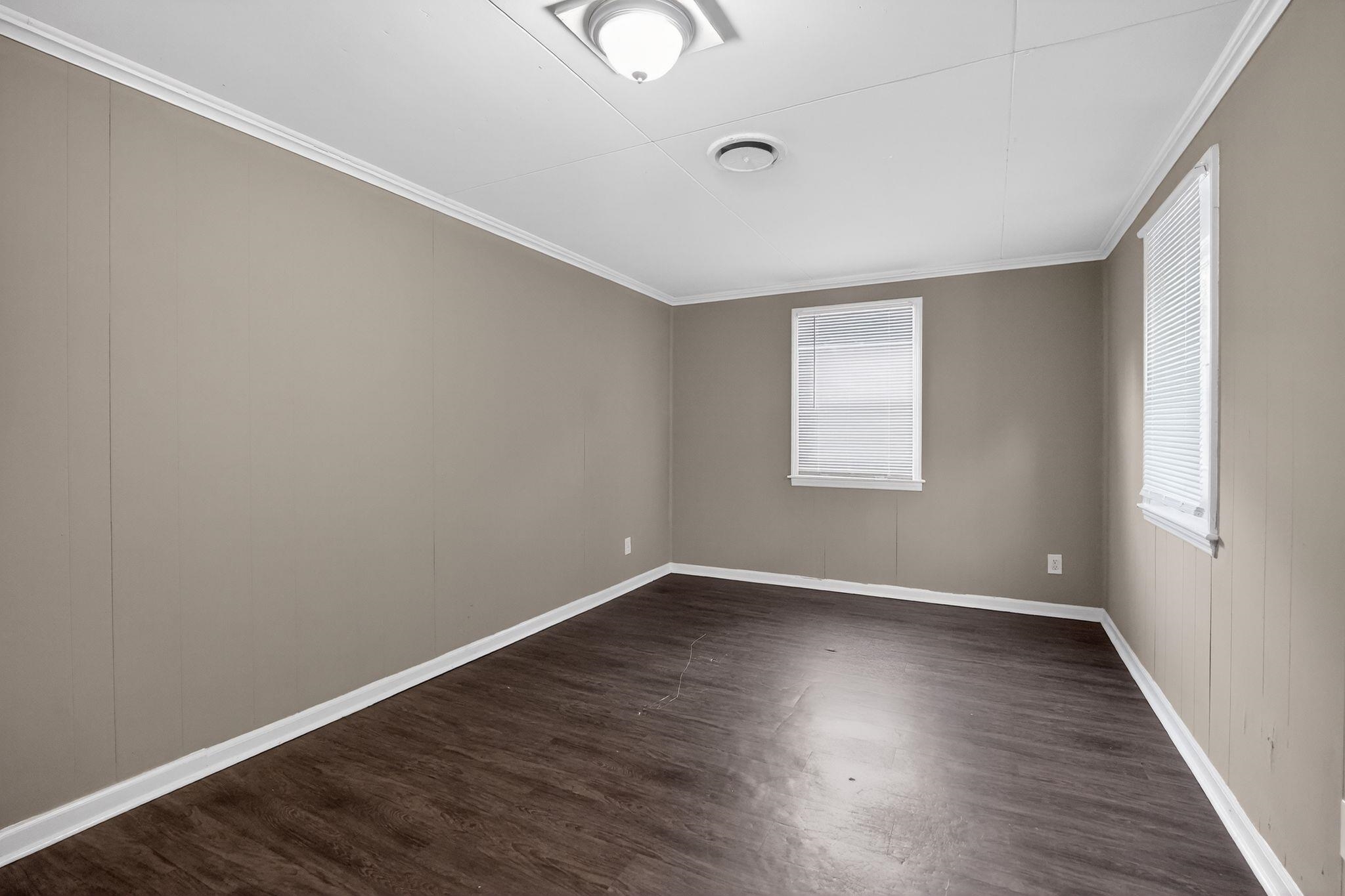 3603 England Street Memphis, TN 38127 - Photo 19 of 36 Unfurnished room featuring dark wood finished floors and ornamental molding