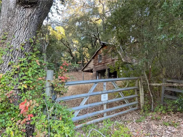 a view of house with large window and wooden fence